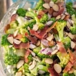 Need a quick and easy side dish? You have to try our Favorite Broccoli Salad recipe! The flavor combination of the broccoli, bacon, almonds and grapes (with a touch of mayo and sugar) is perfect. Makes a fabulous side dish for your next meal, plus it is always a hit at potlucks!