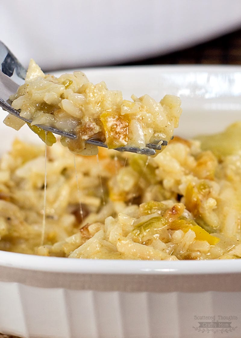 Serving of cheesy green chile chicken and rice casserole on a fork