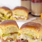 These Spicy Cuban Sliders are the perfect little handful of flavor. The shredded pork, ham and swiss cheese come together to make one delicious warm and cheesy slider! Bonus: they're super easy to make and are perfect for lunch or dinner.