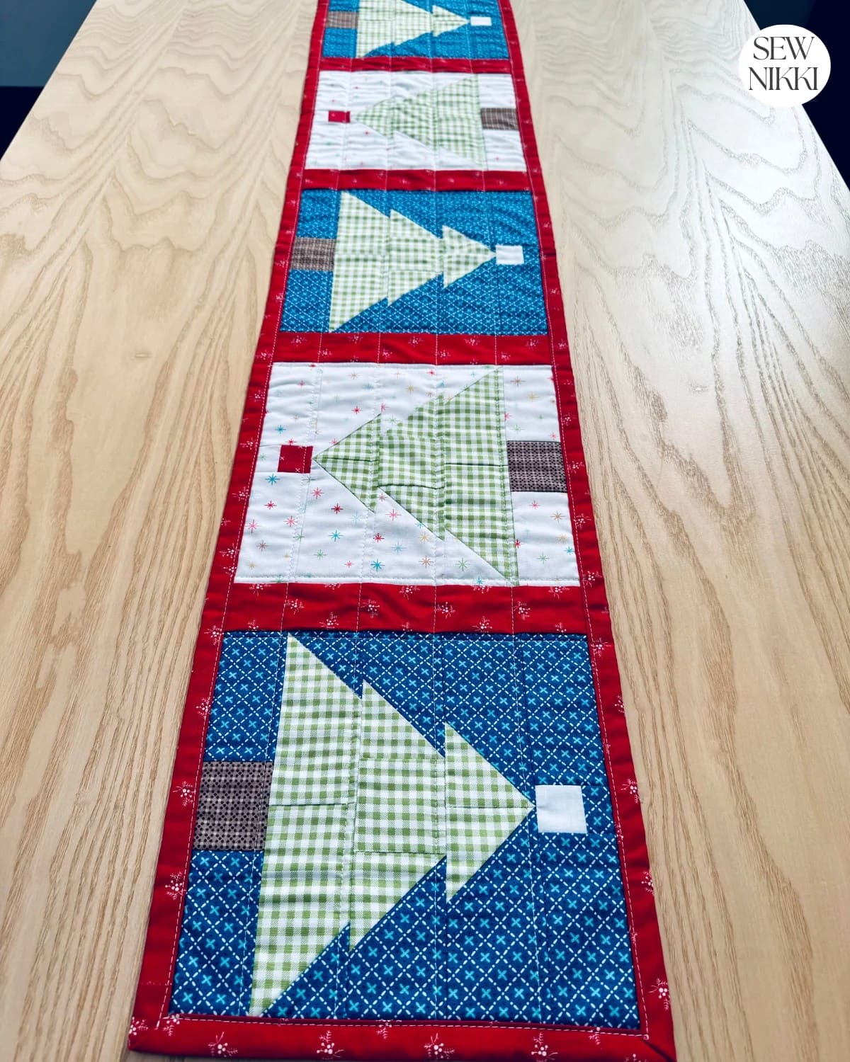 Quilted Christmas tree table runner in red, green, and white fabrics