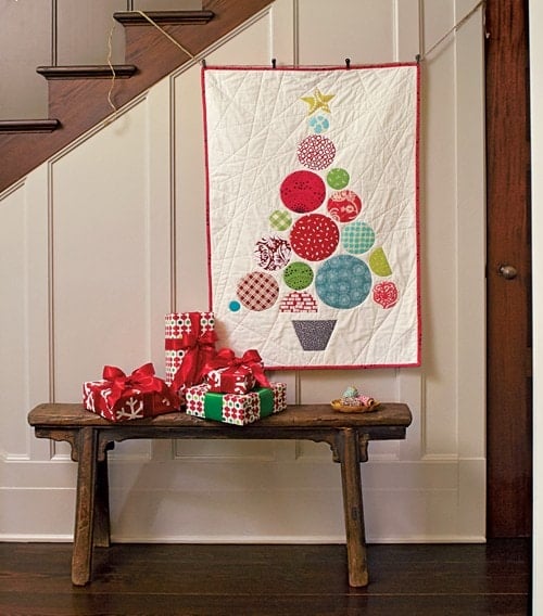 Modern Christmas tree quilt made from colorful pieced circles