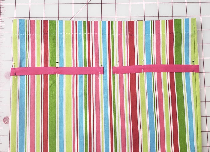 Pink casing pinned around the outside of the sack with a gap between the ends