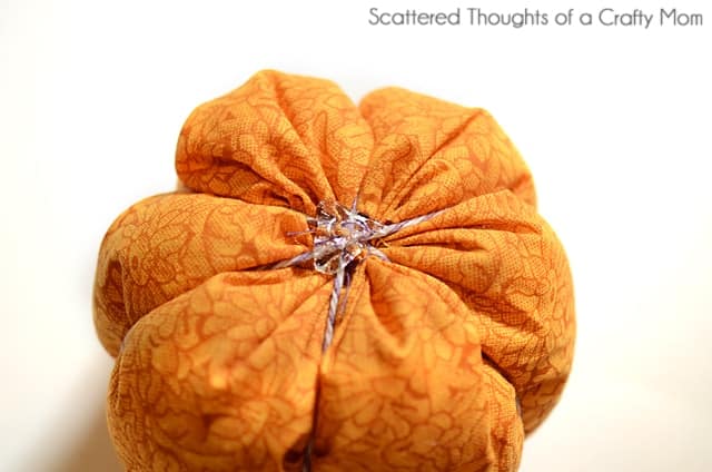 Wrapping twine around a fabric pumpkin