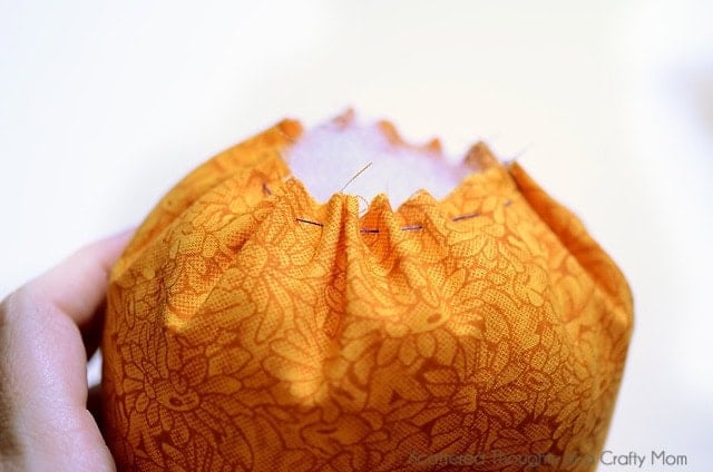 Stuffing a fabric pumpkin