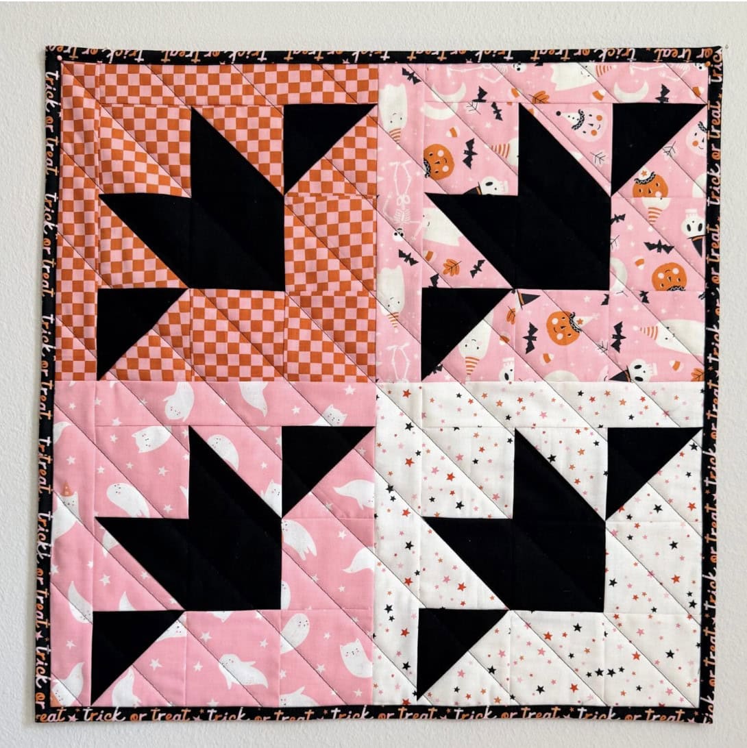 Halloween bat mini quilt with black bat blocks on an orange background