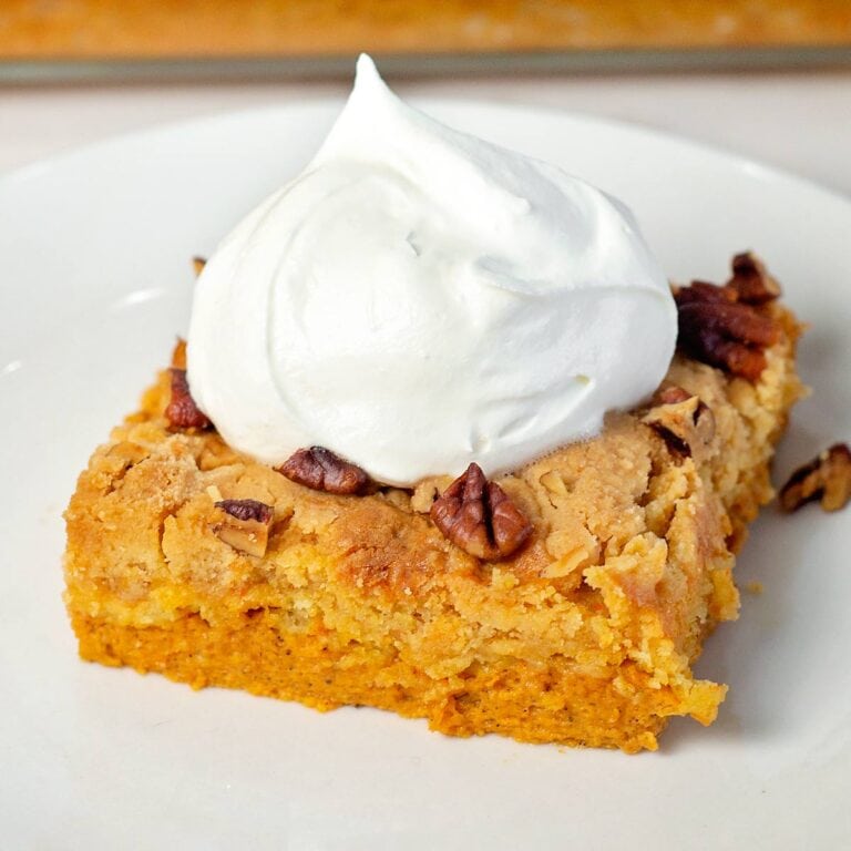 slice of pumpkin dump cake with cool whip