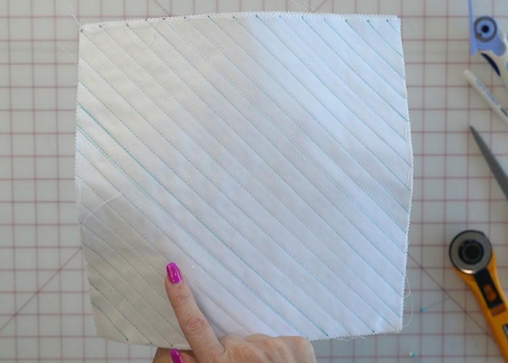 Sewing diagonal lines through the stacked fabric layers
