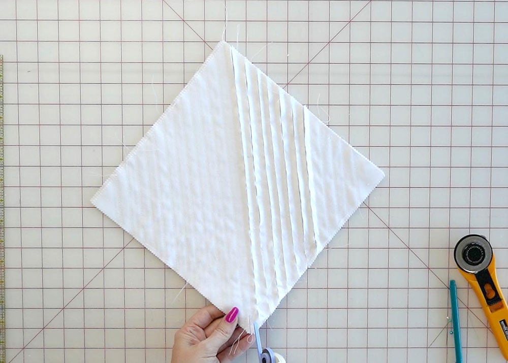 Cutting between stitched rows to create the chenille fabric texture