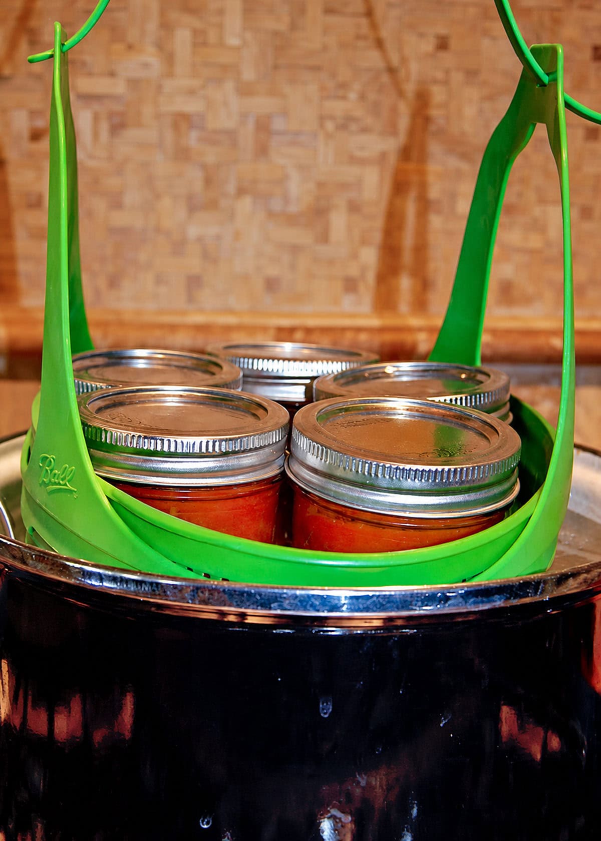 Removing canned pizza sauce jars from the water bath canner