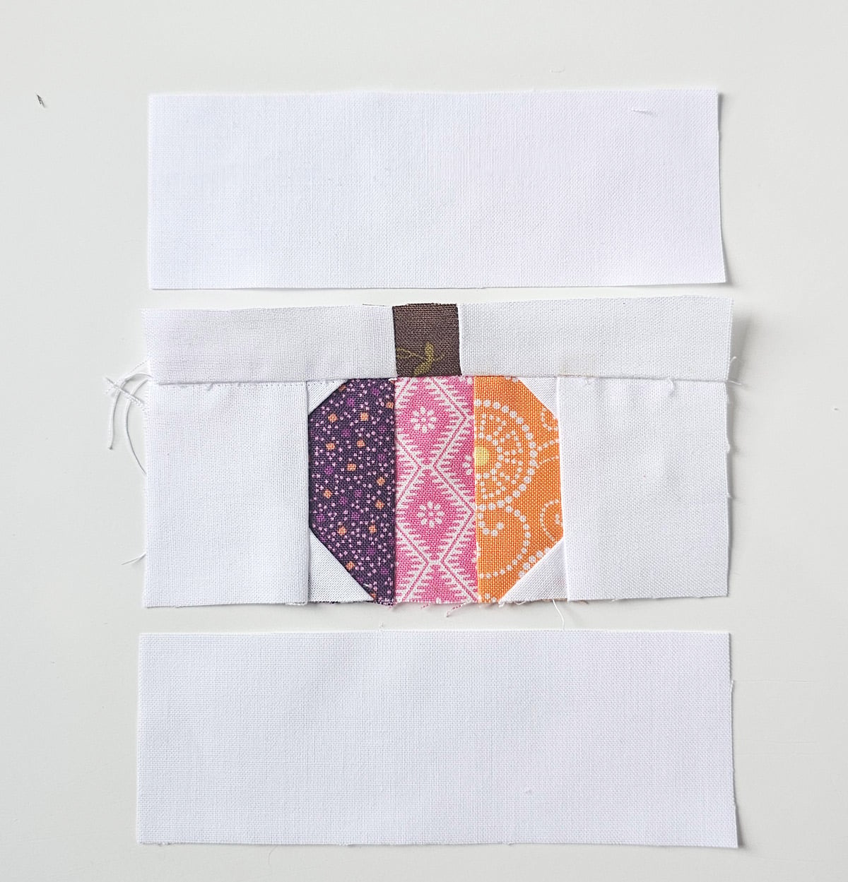White fabric rectangle added to the foundation paper pieced pumpkin block